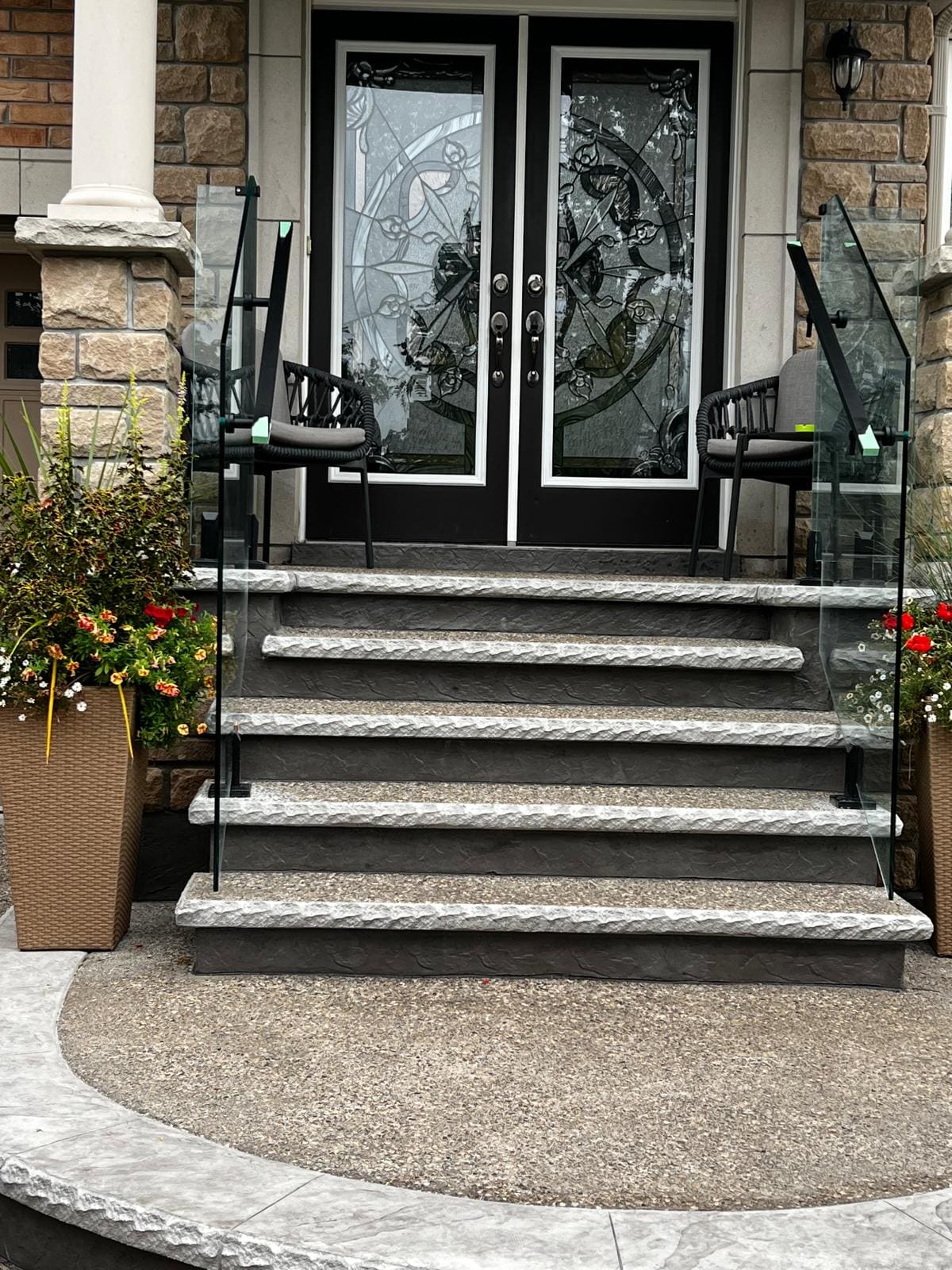 Glass on a front entry stair and porch with a rounded landing