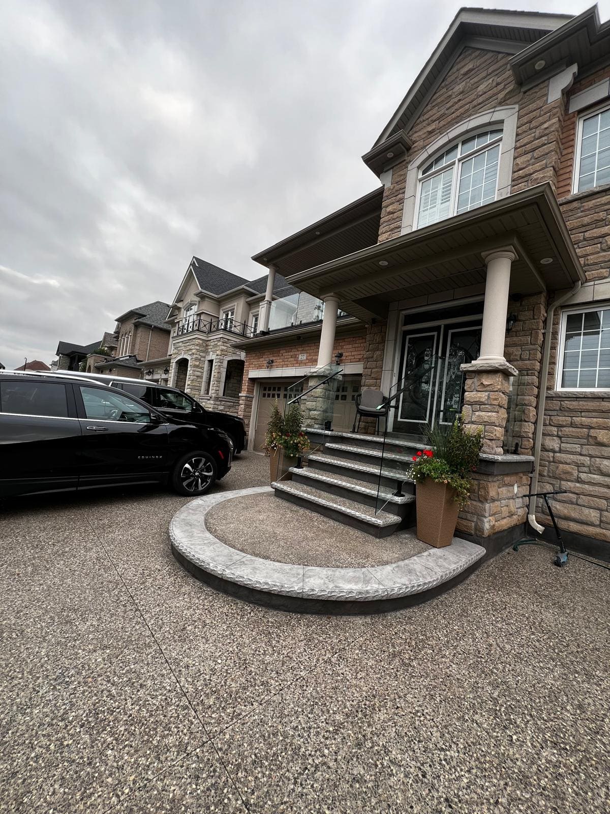 Glass on a front entry stair and porch with a rounded landing