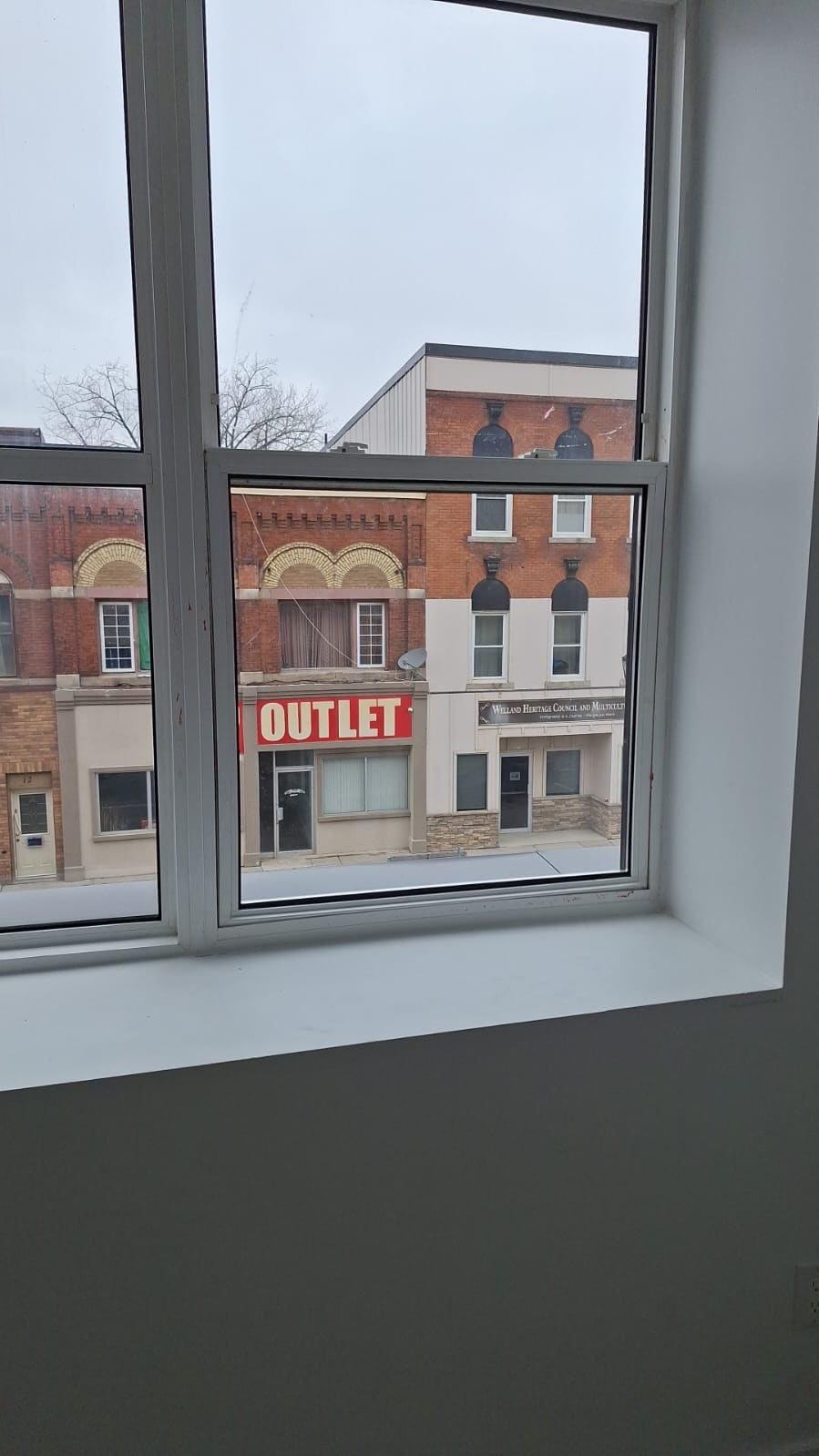 Upper-floor window over a main street, replaced