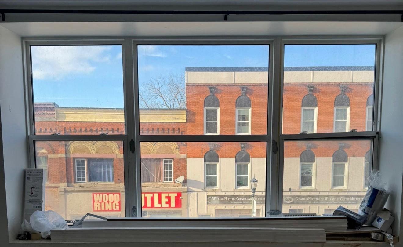 Upper-floor window over a main street, replaced