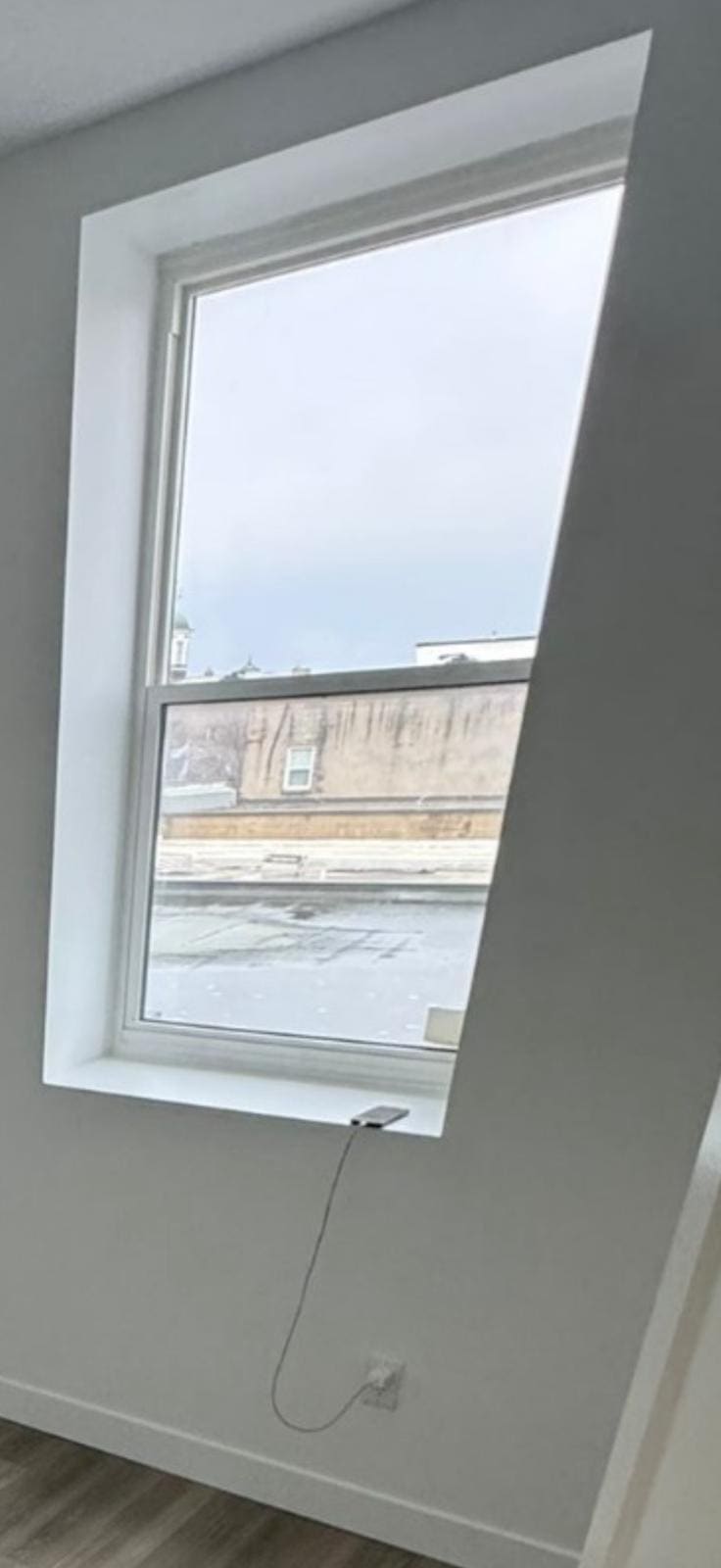 Upper-floor window over a main street, replaced