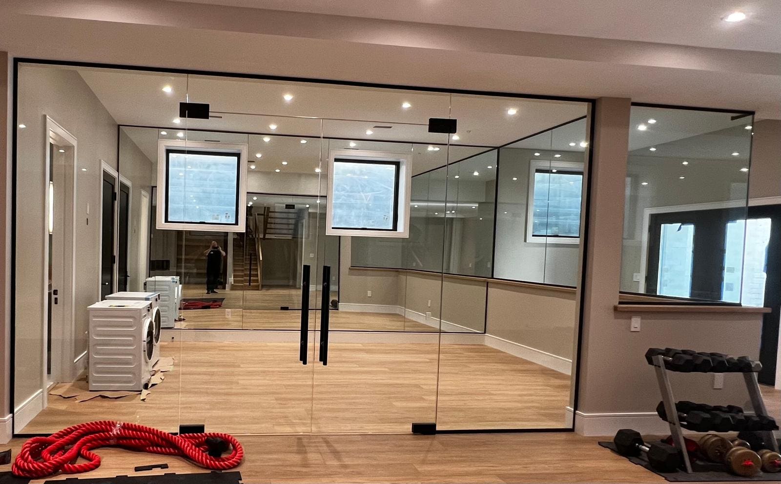 Glass wall and door closing off a home gym