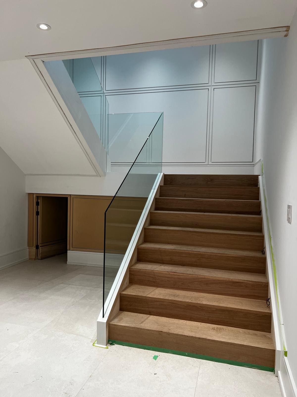 Frameless glass around a switchback stair in a double-height hall