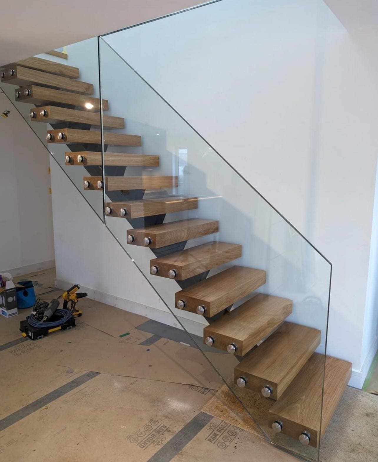 Interior Stairs — Glass balustrades for stairs and open landings — frameless, on standoffs or along the stringer, measured on site.