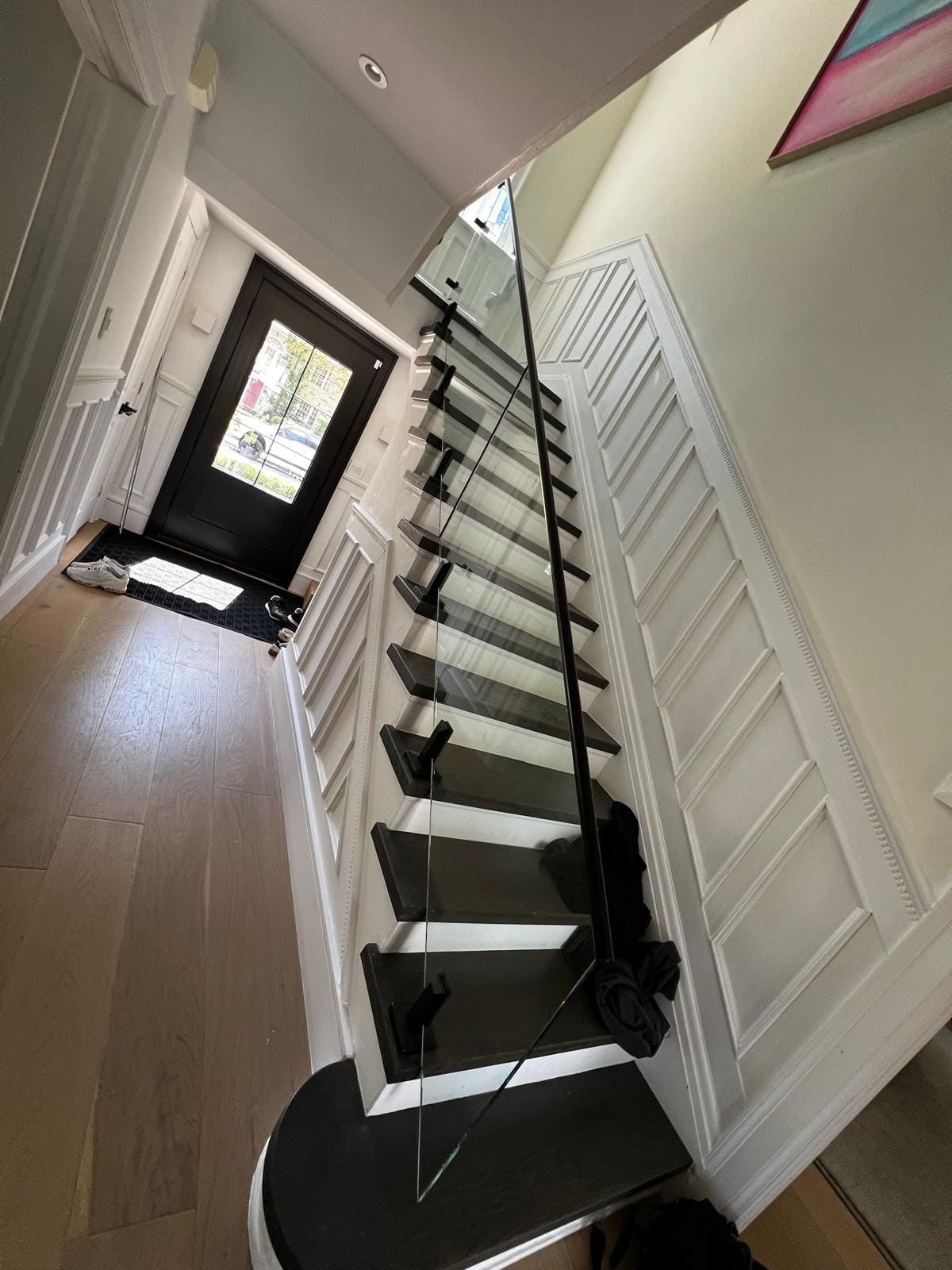 Frameless glass along a stair with dark treads