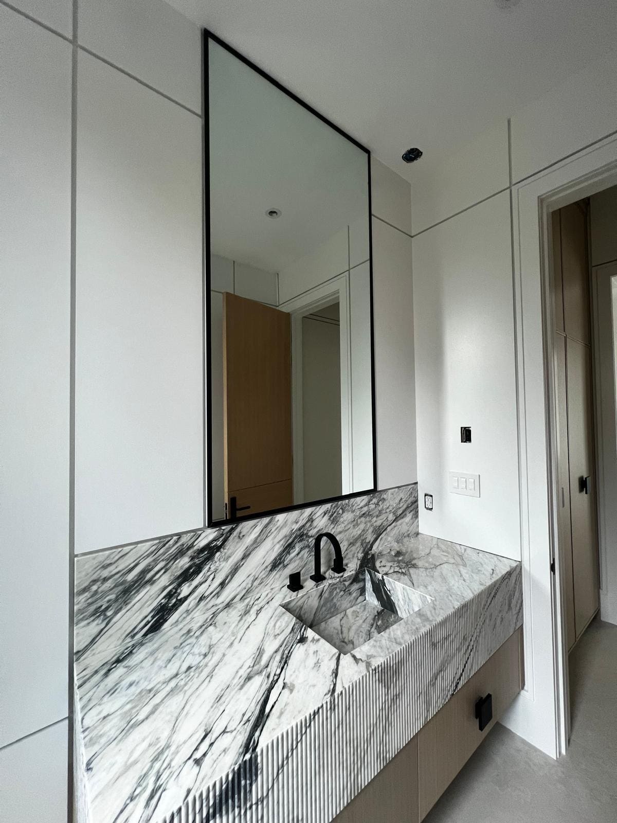 Mirrors — Custom mirrors cut to any size — vanities, feature walls, black-framed or with polished edges.