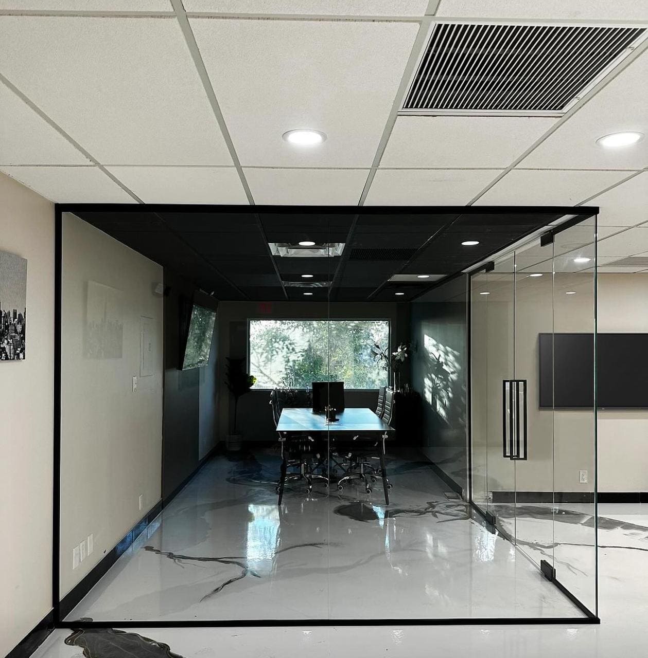 Black-framed glass meeting room with double doors