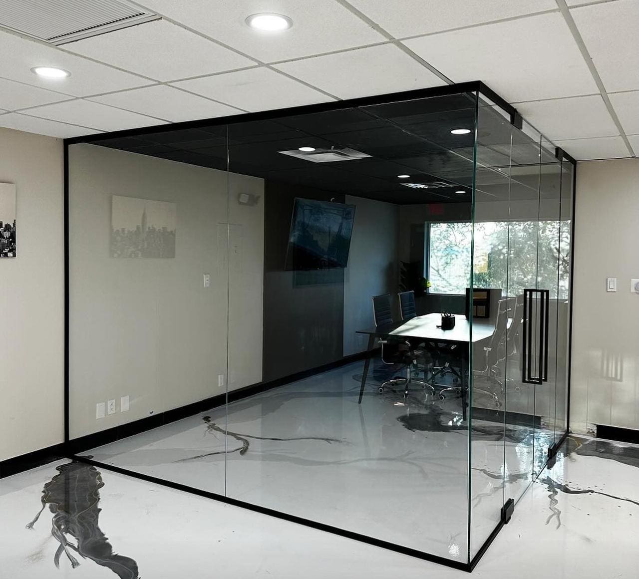 Black-framed glass meeting room with double doors