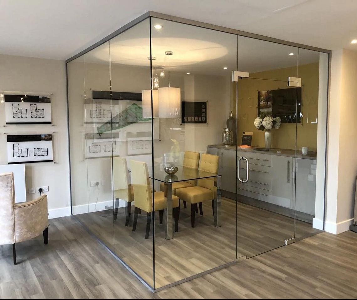 Frameless glass corner room in a sales office