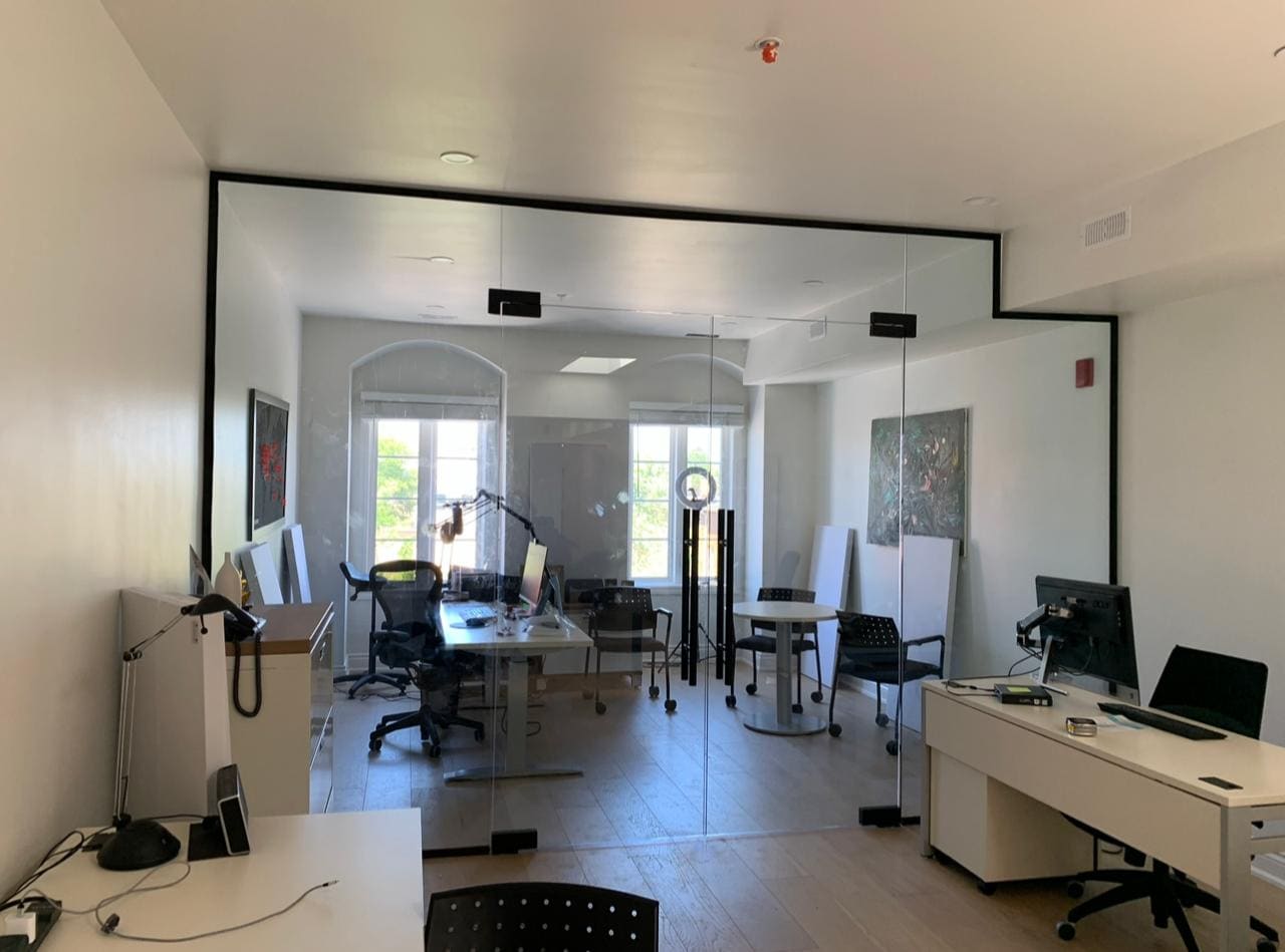 Black-framed glass partitions in an open-plan office
