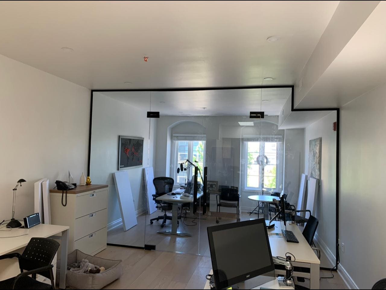 Black-framed glass partitions in an open-plan office