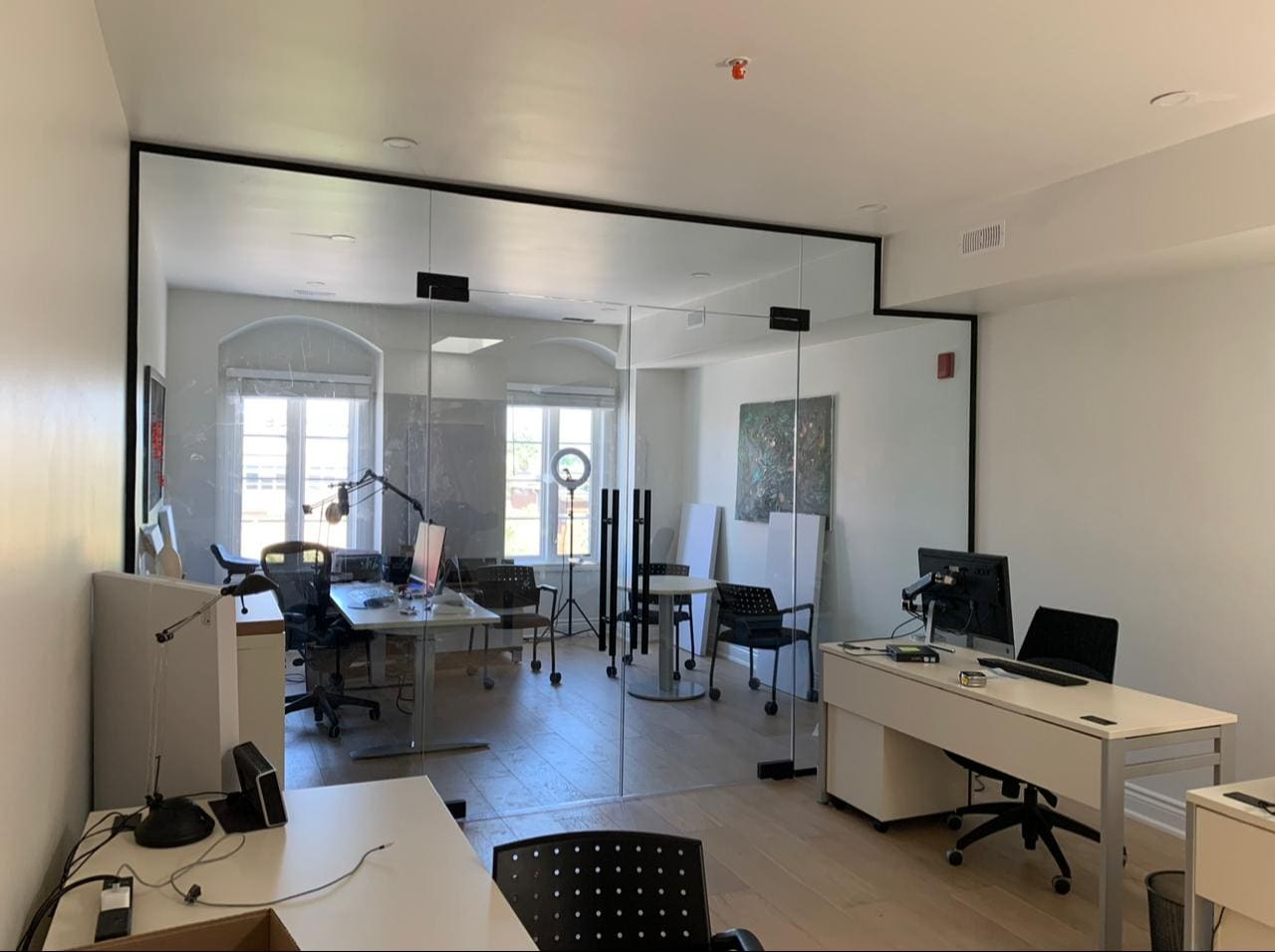 Black-framed glass partitions in an open-plan office