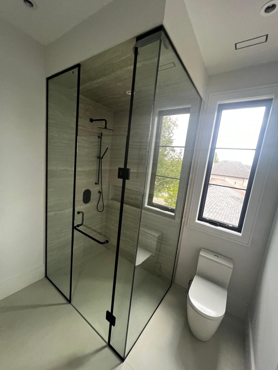 Black-framed shower in a new-build bathroom