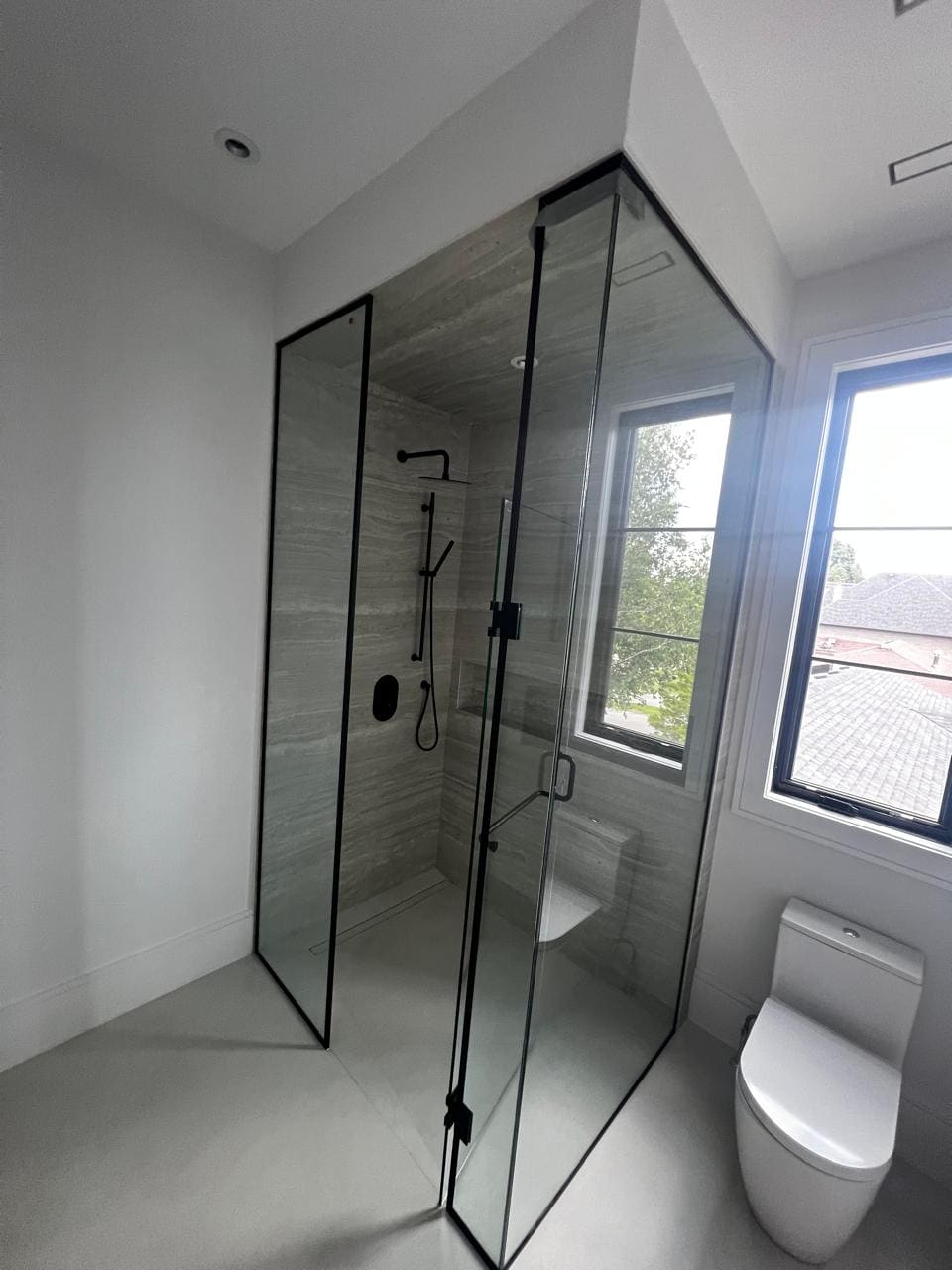 Black-framed shower in a new-build bathroom