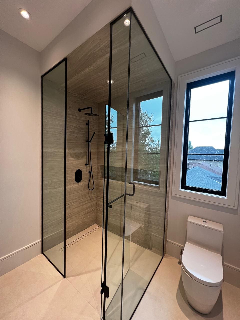Black-framed shower in a new-build bathroom