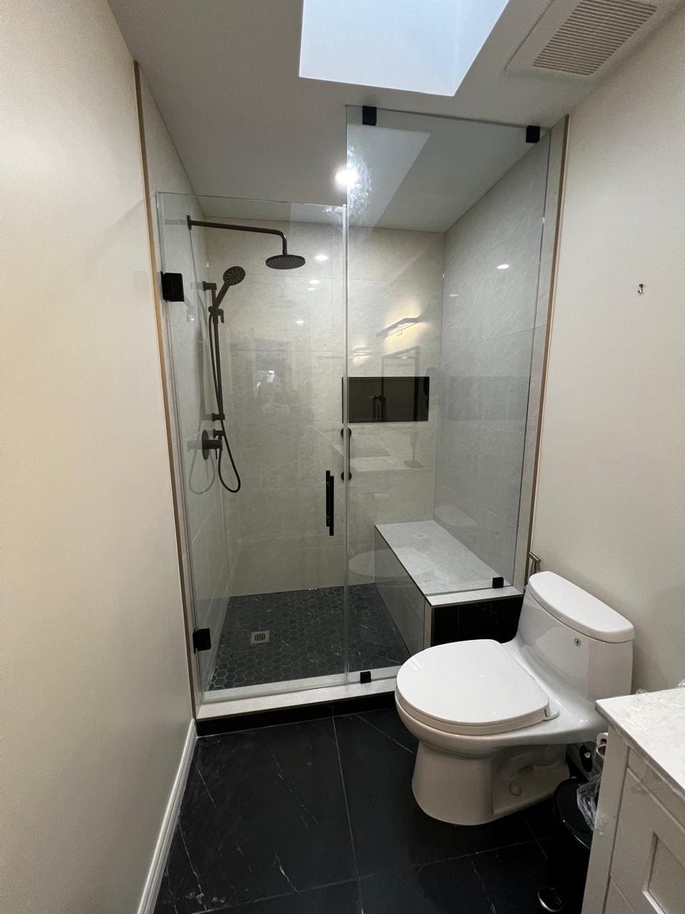Frameless shower under a skylight